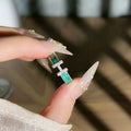 Mint green enamel asterism ring with asymmetric folded copper design and eight-point star pattern