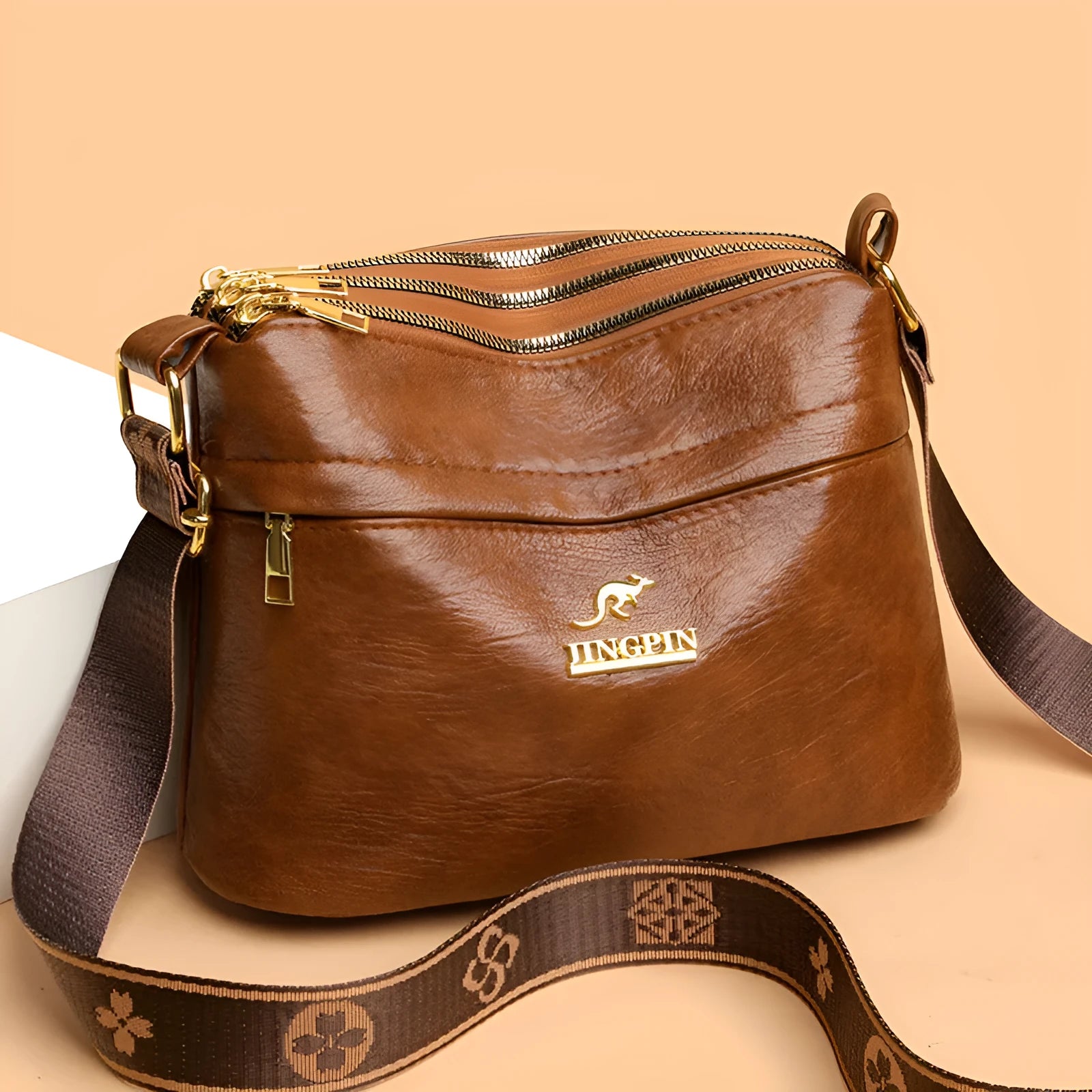 Brown cross body messenger bag with multiple compartments and sewing thread details on PU material