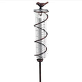 Cast iron hummingbird-shaped rain gauge with glass measurement tube showing 0-800ml capacity scale