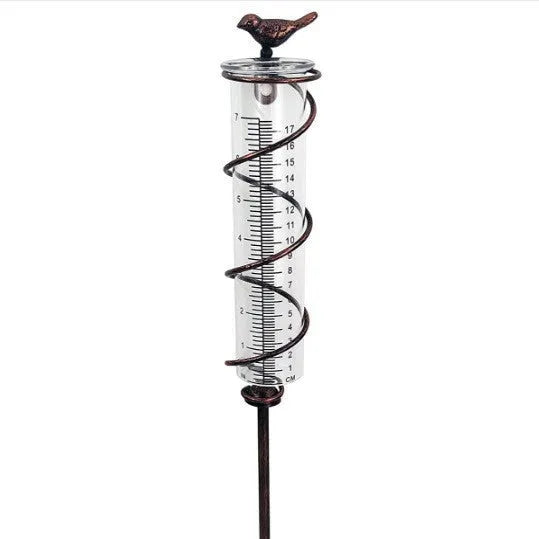 Cast iron hummingbird-shaped rain gauge with glass measurement tube showing 0-800ml capacity scale