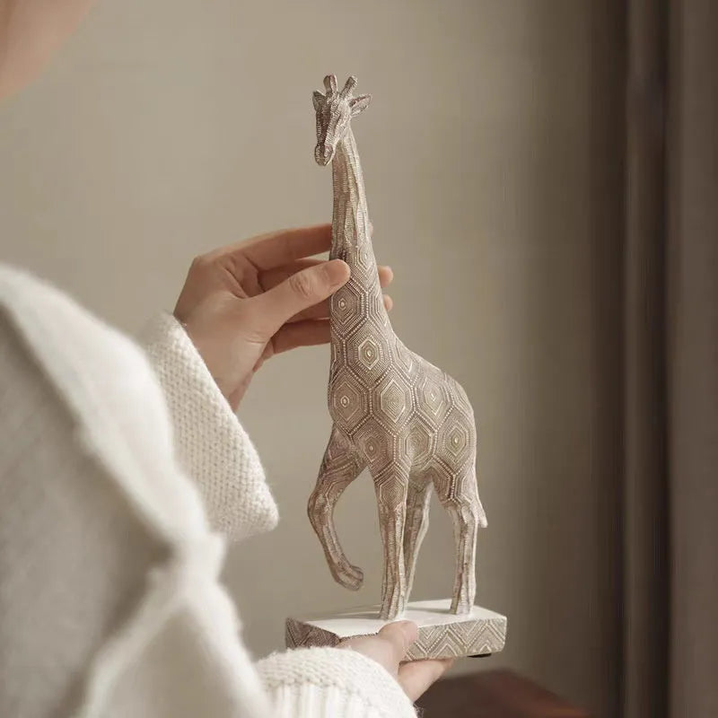 Wood colour European style giraffe resin ornament on a surface.
