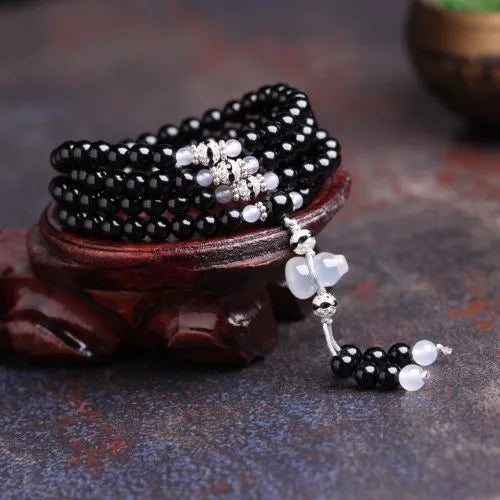 Natural red and black agate 108 bead prayer bracelet with geometric shapes.