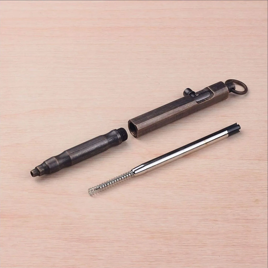 Brass hexagonal bolt-action tactical pen in brass and retro black colours, showing machined details.