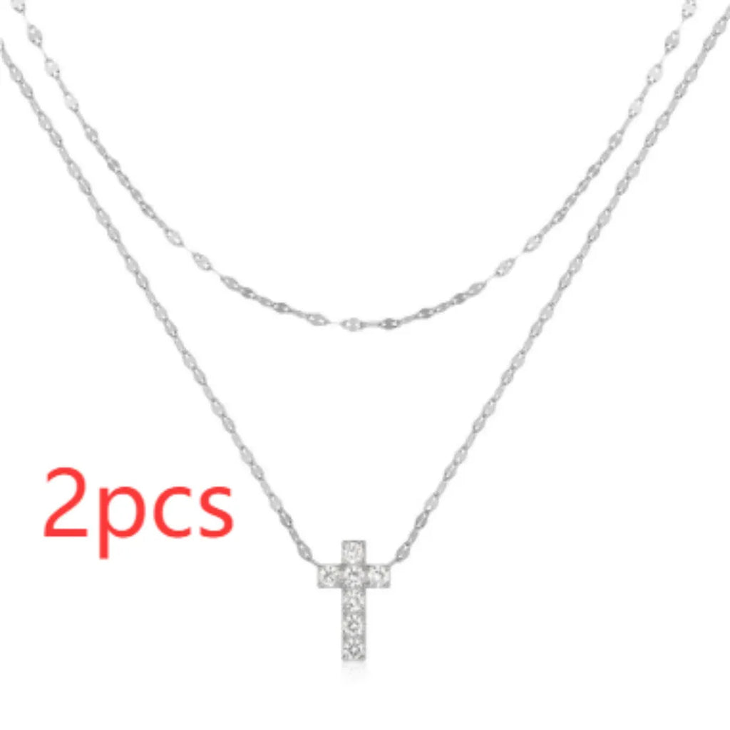 S925 sterling silver double layer twin diamond cross pendant on a gold plated clavicle chain.