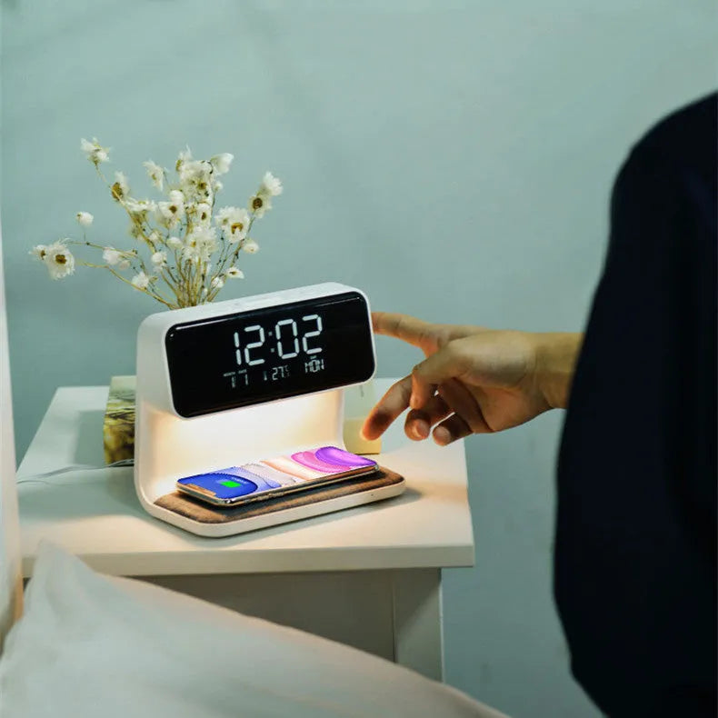 White bedside lamp with integrated wireless charging pad and LCD alarm clock display