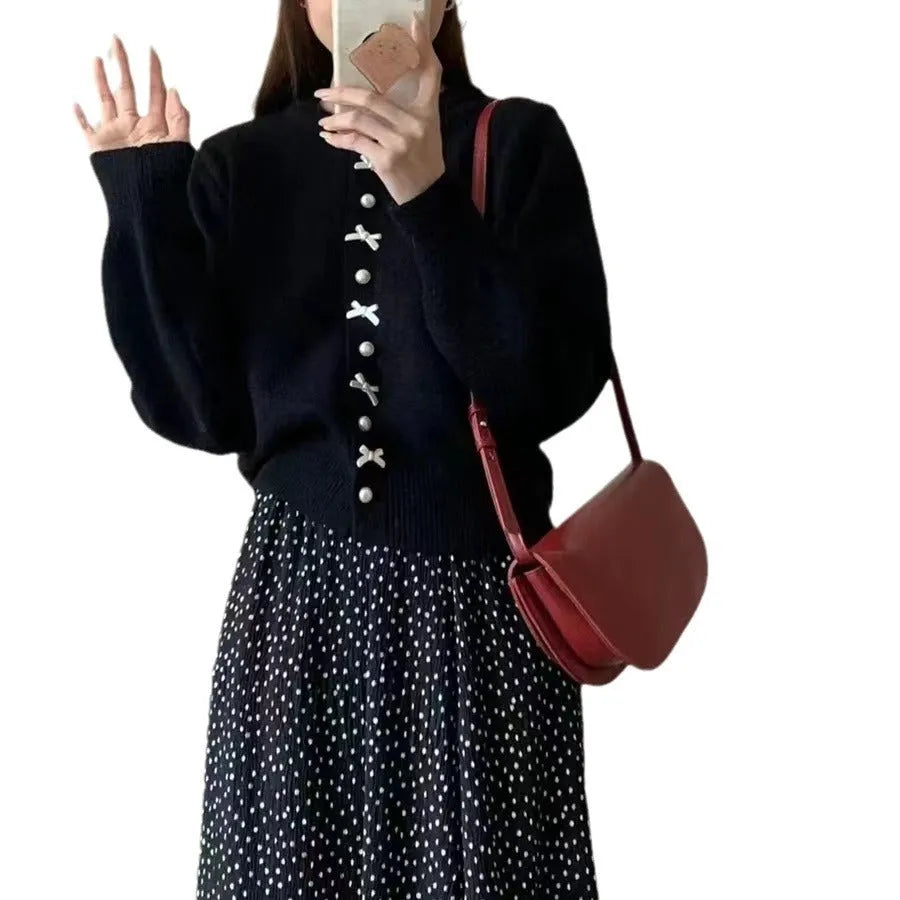 Women's light blue cashmere blend cardigan sweater with a bow and pearl buttons.