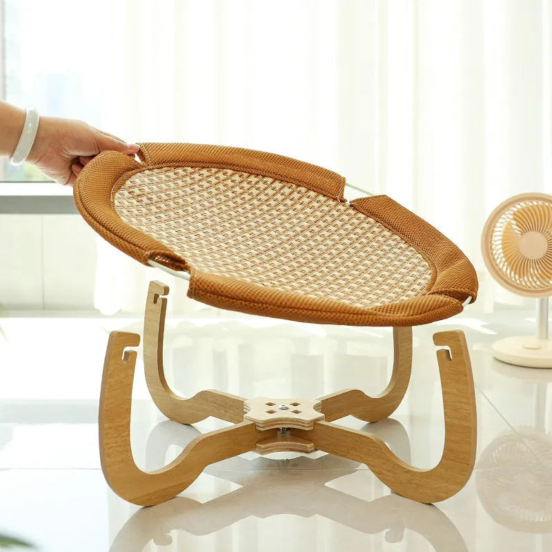 Brown woven rattan square pet hammock bed elevated off the ground.