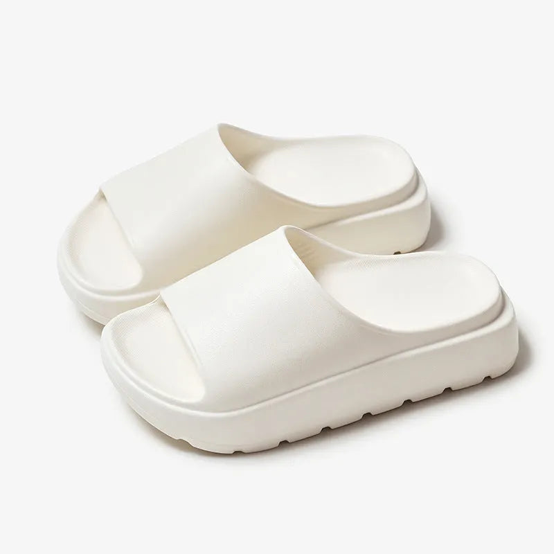 Women's beige fish mouth slippers with a thick EVA sole on a bathroom tile floor.