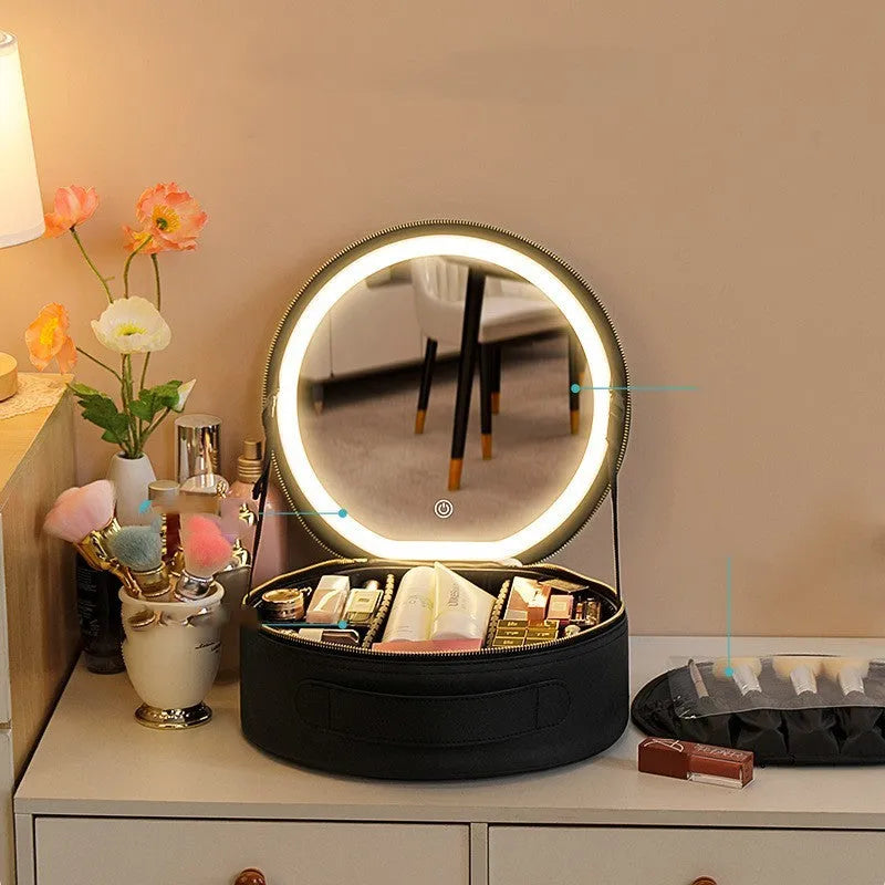 Round pink PU leather makeup bag open showing illuminated mirror and internal partitions.
