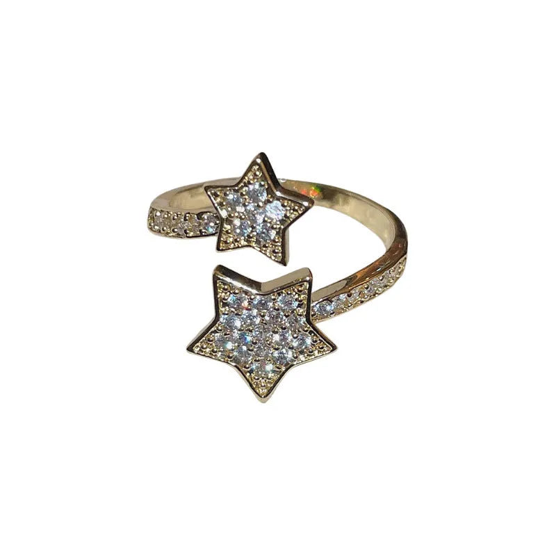 Gold cold style zircon star open-end ring and bracelet set on white background