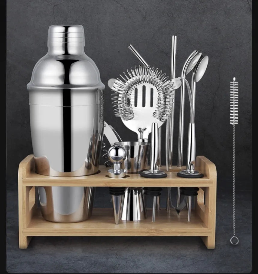 23-piece stainless steel cocktail set with drink mixers on a bar