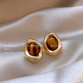 Three pairs of handmade geometric alloy earrings with electroplated finishes and tassel details