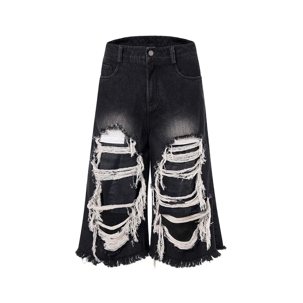Black wide-leg cropped jeans with distressed patchwork detail and a mid-high waist.