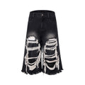 Black wide-leg cropped jeans with distressed patchwork detail and a mid-high waist.