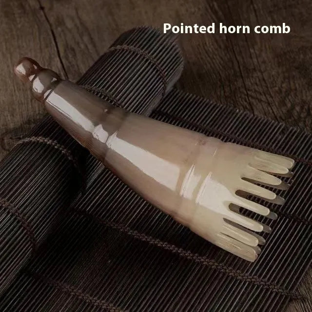 Black buffalo horn comb with wide teeth and pointed tip for scalp massage