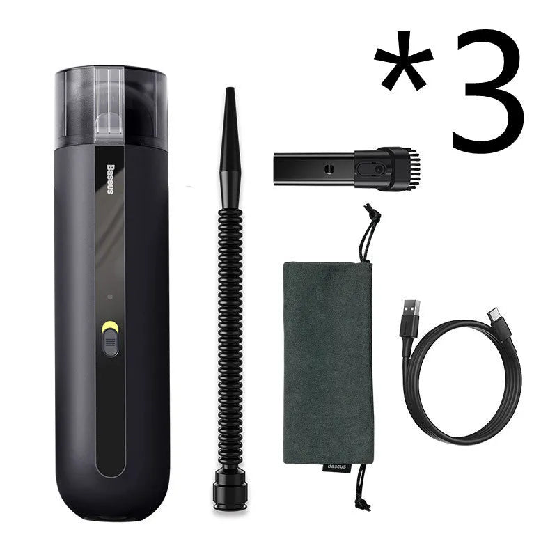 Starry sky black handheld cordless car vacuum cleaner with blowing hose accessory on a desktop.