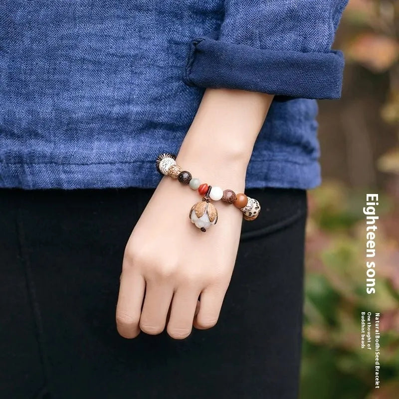 Women's 18-seed Bodhi bead bracelet with elastic cord and geometric design