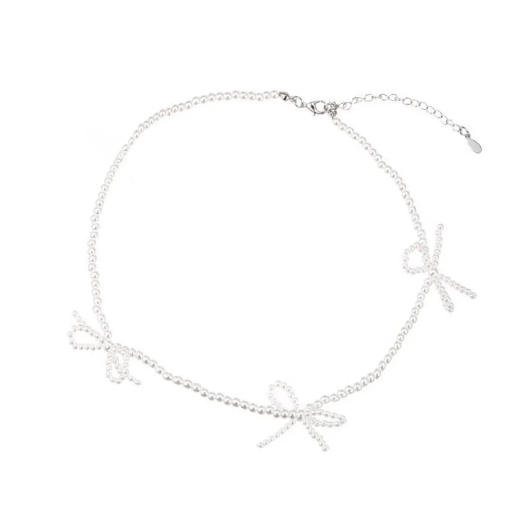 Women's white imitation pearl necklace with sweet bow design and geometric shapes on adjustable chain