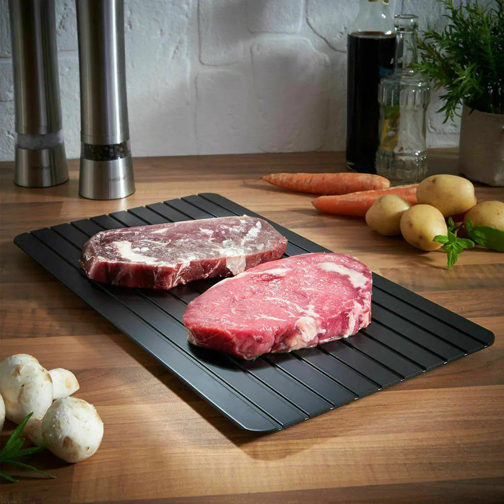 Black rectangular aluminium fast defrost tray for thawing frozen meat and fish