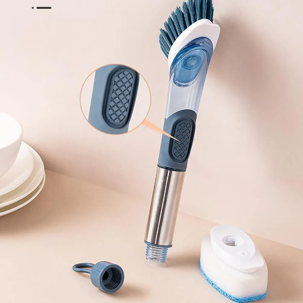 Blue long-handled kitchen dish brush with built-in soap dispenser button, sponge, and scouring block.