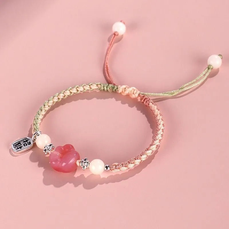 Red cat's paw charm couples bracelet with pink woven base, handmade glass and glaze jewellery