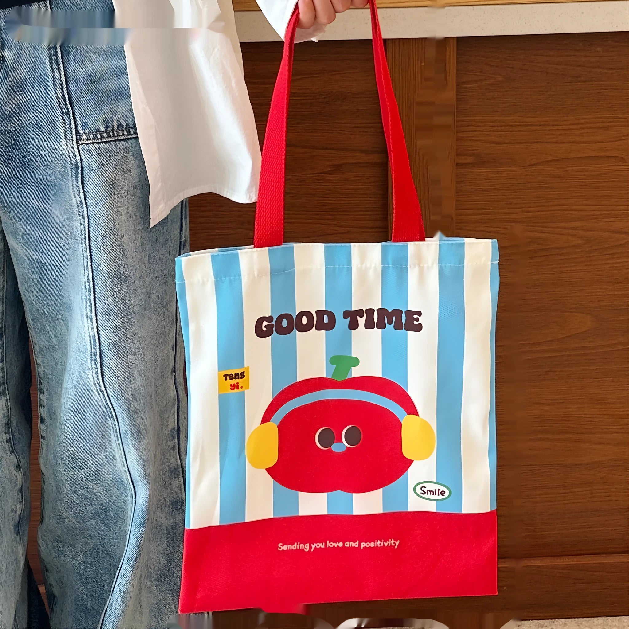 Cartoon print canvas handbag showing colourful design with 30x36x24cm dimensions