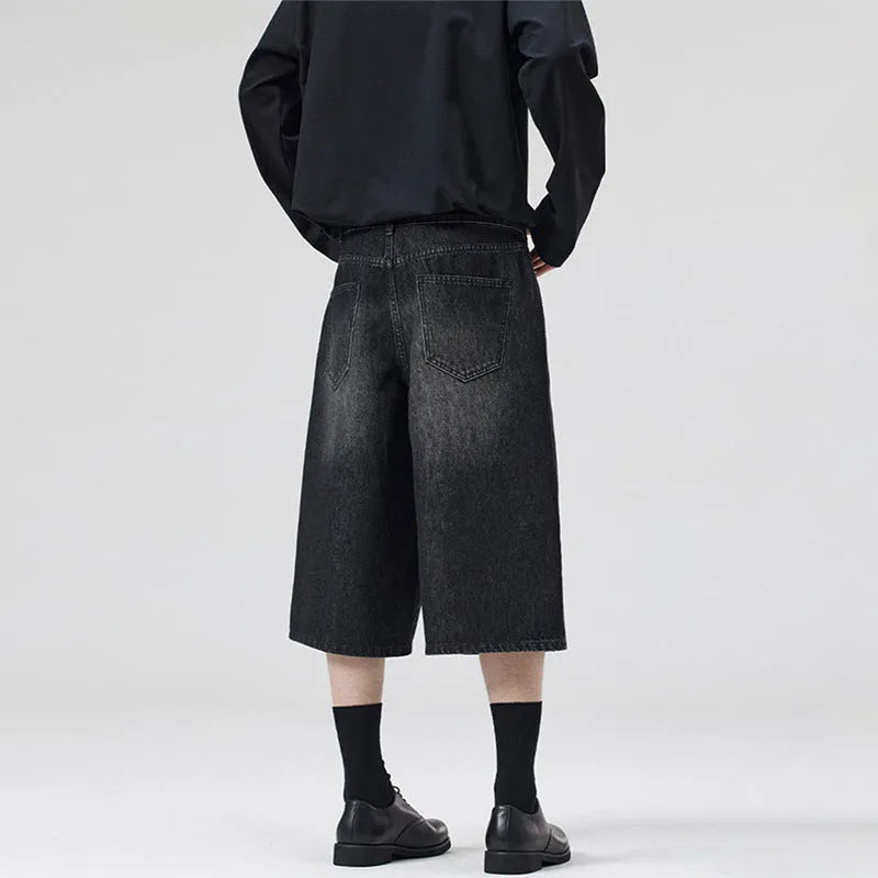 Man wearing light blue straight-leg cropped denim shorts for casual summer wear.