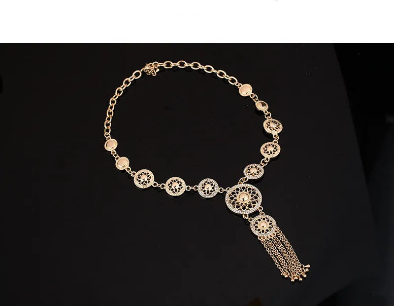 Gold alloy jewellery set with earrings, necklace, and bracelet featuring star and celestial pattern on a light background