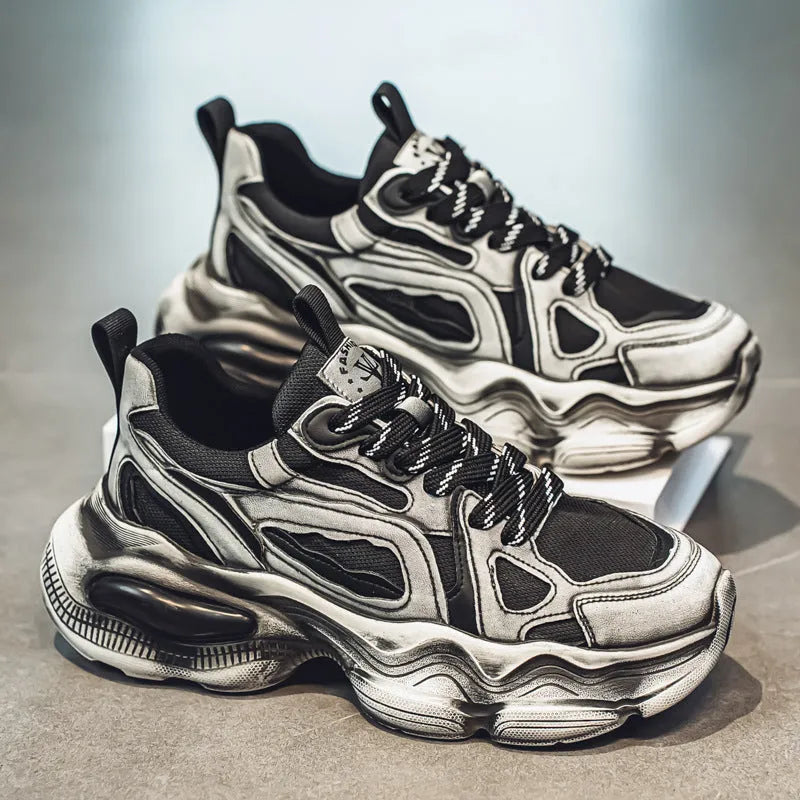Men's black and grey mesh sneakers with a platform heel, round toe, and cross strap detail on a white background.