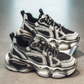 Men's black and grey mesh sneakers with a platform heel, round toe, and cross strap detail on a white background.