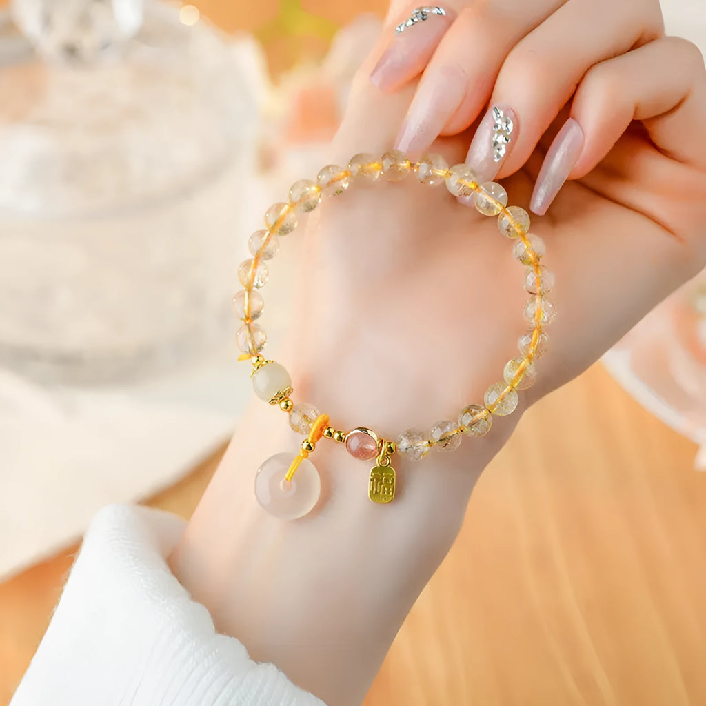 Gold rutilated quartz crystal bracelet with geometric design and safety buckle