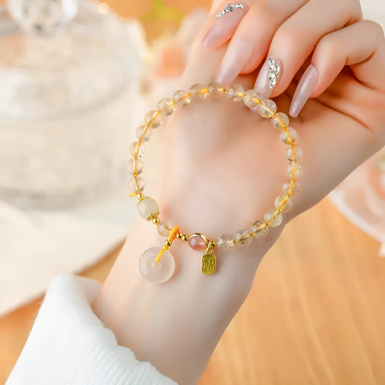 Gold rutilated quartz crystal bracelet with geometric design and safety buckle