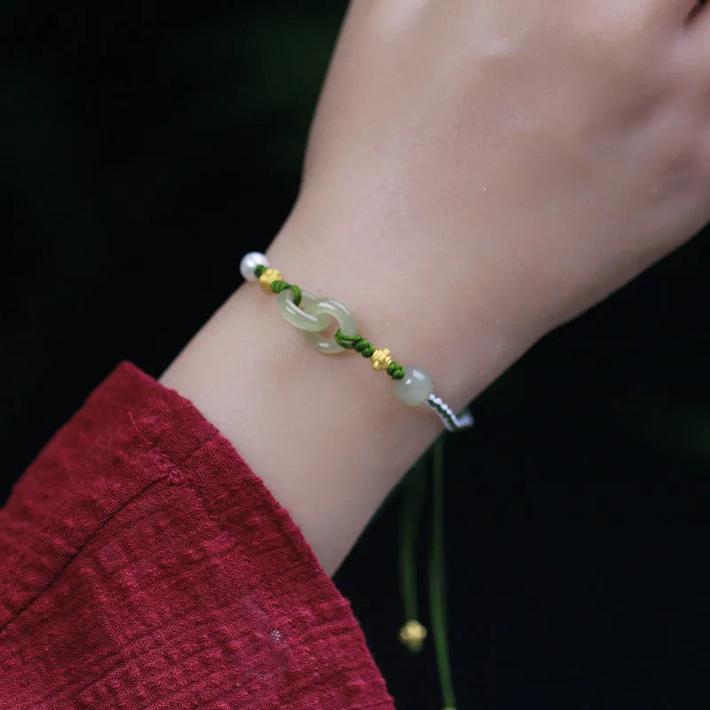 Natural Hetian jade pendant on woven wire bracelet with hollow-out design