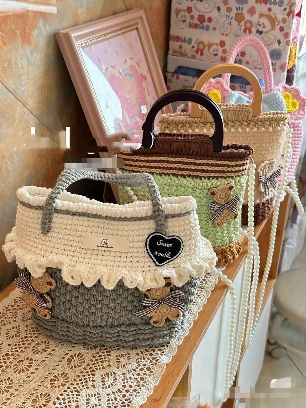 Wool crocheted bear shoulder bag with wooden handle on a crossbody strap