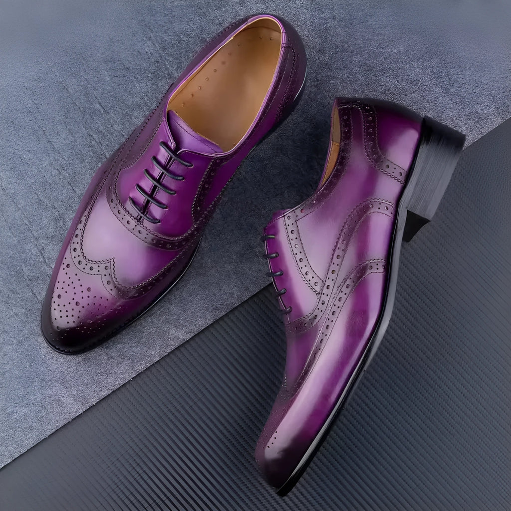 Men's purple leather Oxford dress shoes with hand-carved detailing and pointed toe on a rubber sole.