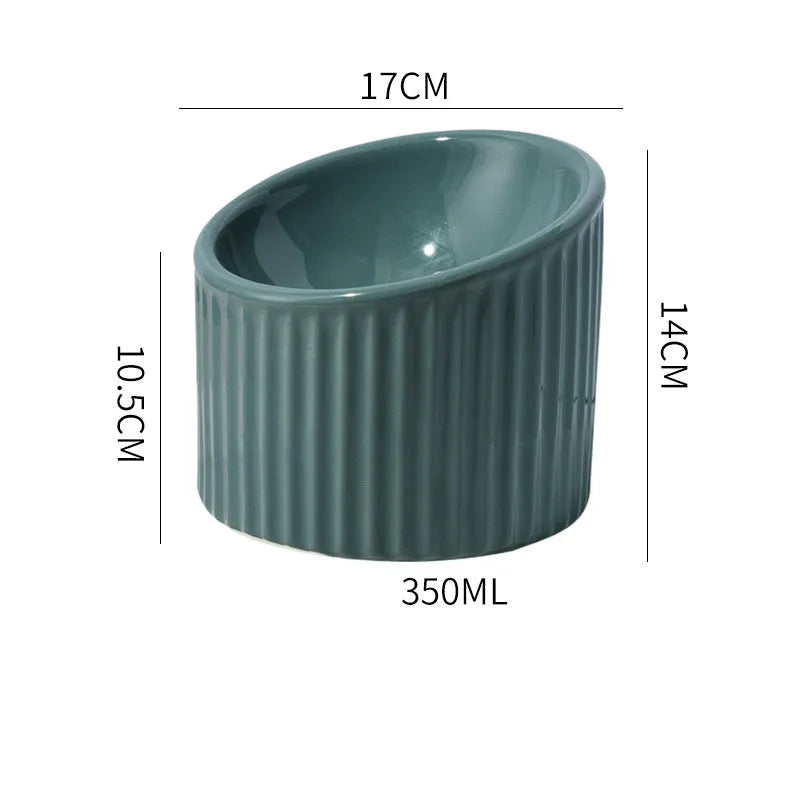 Ceramic elevated cat food bowl in green, showing tilted round dish on a raised stand.