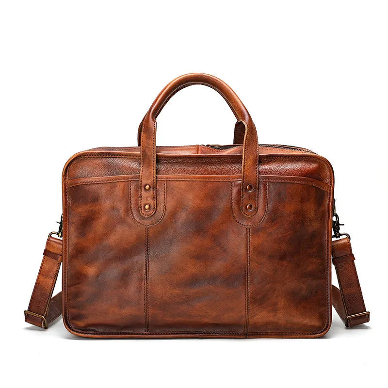 Brown vintage leather men's briefcase showing internal organiser pockets for laptop, documents, and phone.
