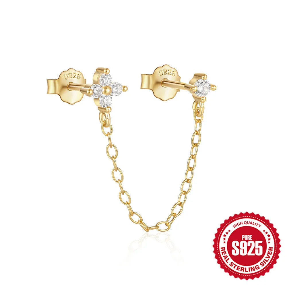 Close-up of a geometric S925 sterling silver clip-on earring featuring a diamond flower and a delicate gold-plated chain tassel.