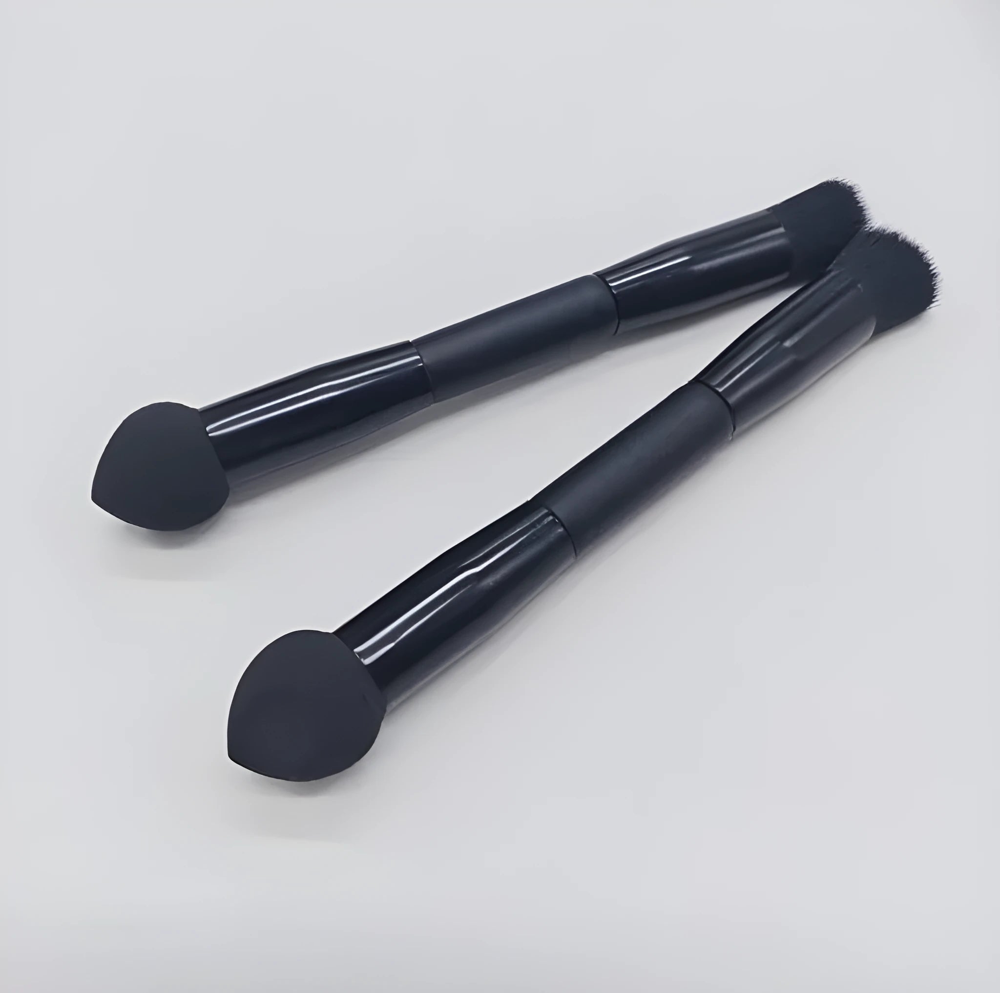 Double-headed miter sponge concealer brush with black artificial fibre bristles on wooden handle