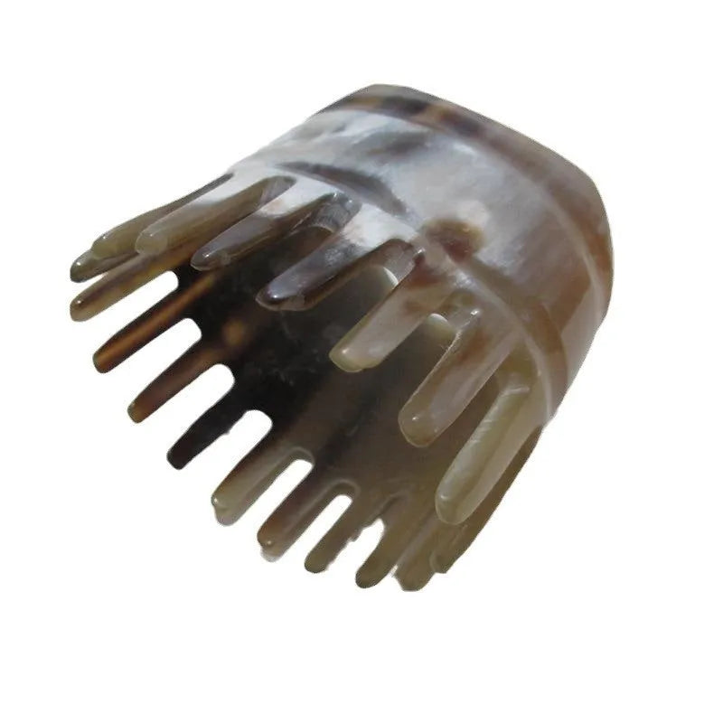 Black buffalo horn comb with wide teeth and pointed tip for scalp massage