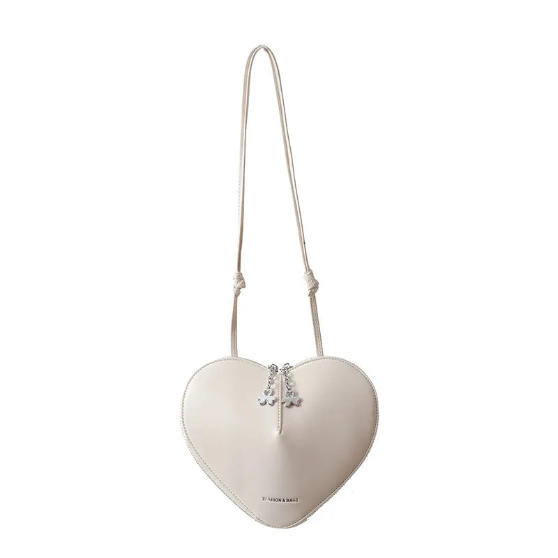 Heart shape women's shoulder bag in milky white PU with single crossbody strap and sewing line detail
