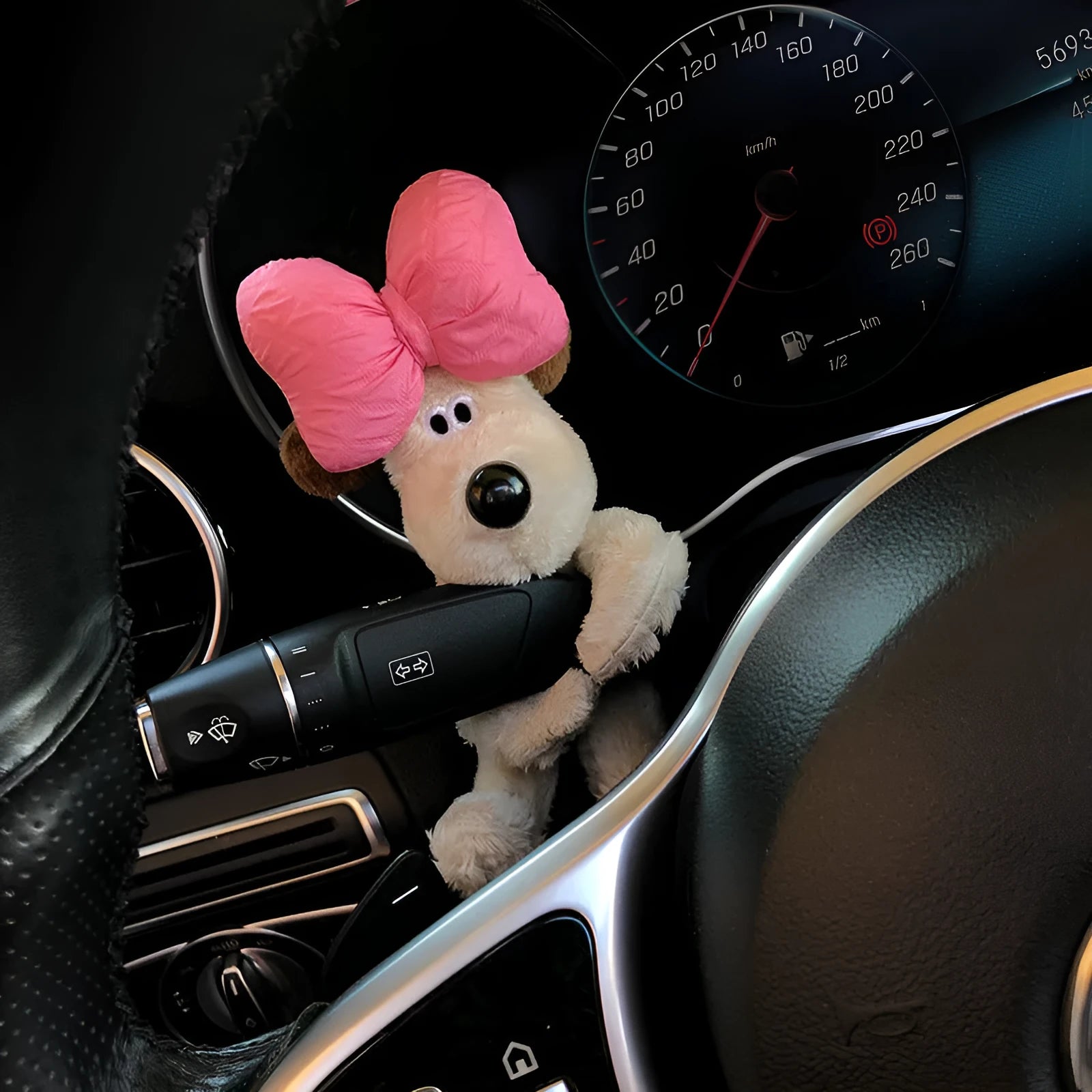 Cute cotton car decoration doll showing a pilot dog design on a dashboard.