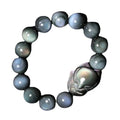 Obsidian fox carved bracelet in cartoon animal style showing detailed carving on black stone surface