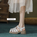Women's black retro platform sandals with chunky heel, hollow out design, and a buckle fastening.
