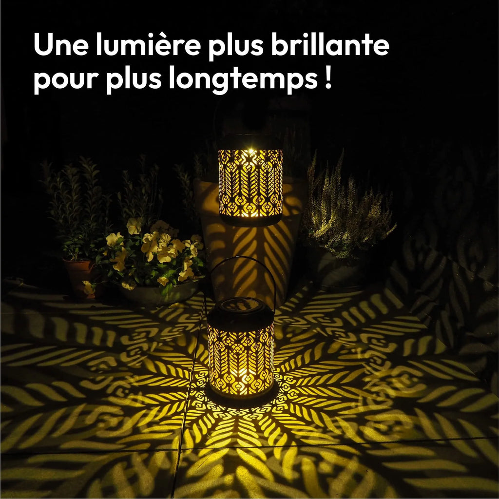 Black iron circular solar lamp with small cylindrical wheat ear design on a garden path