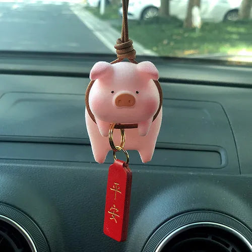 A hard resin cartoon pig car dashboard ornament in one of eight available decorative styles.