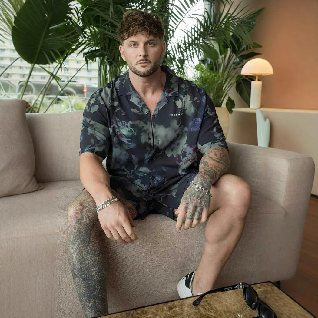 Man wearing a loose-fitting, short-sleeved printed top with a floral pattern in a neutral colour