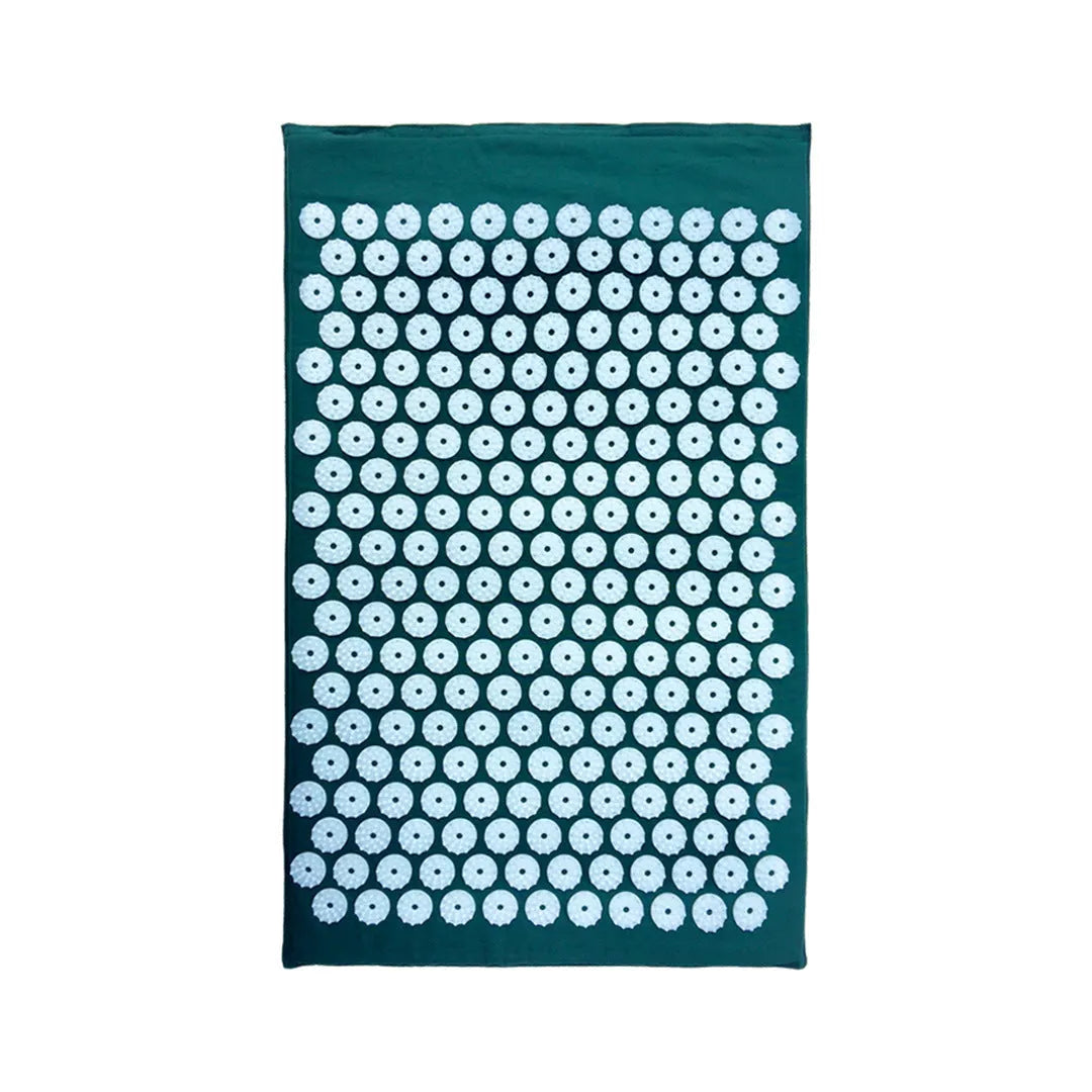 Black and blue acupuncture massage mat set with cushion and headrest on floor for yoga and massage