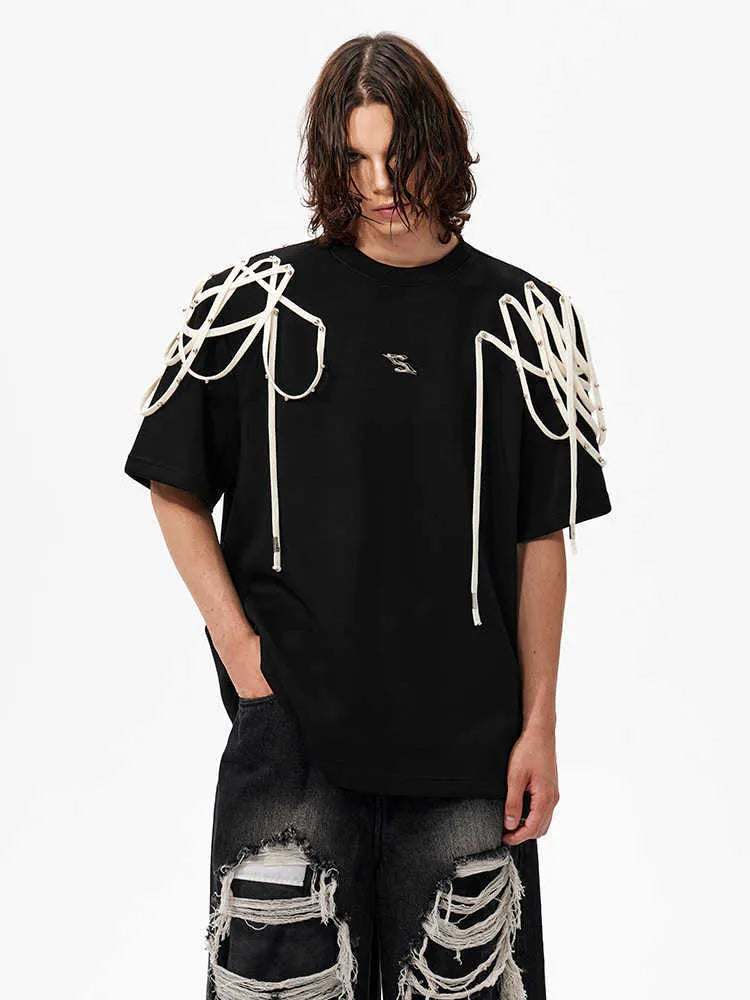 Black loose fit women's T-shirt with padded shoulders and decorative rivet ribbon detail.