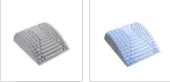 Blue back stretcher pillow for lumbar and neck support on a grey background.